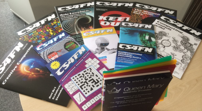 A range of CS4FN magazines next to the Garriott Award for Prof Paul Curzon.png