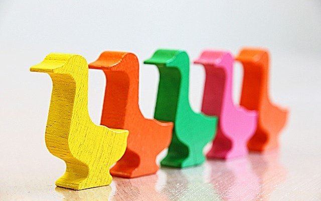 A series of coloured wooden ducks used to illustrate sequences and queues