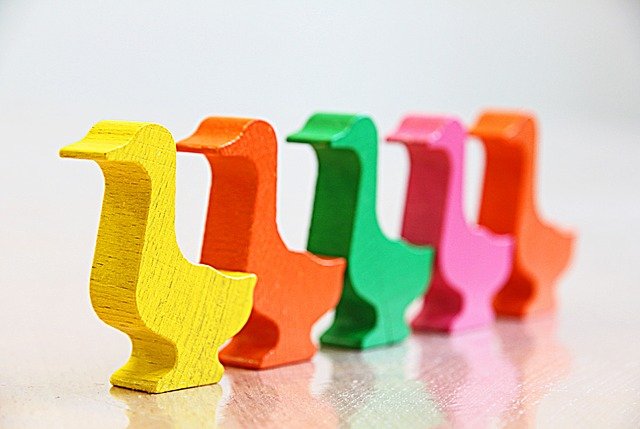 A series of coloured wooden ducks used to illustrate sequences and queues
